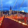 Panoramic view saint georges church footbridge across saone river old town with fourviere cathedral during evening blue hour lyon france