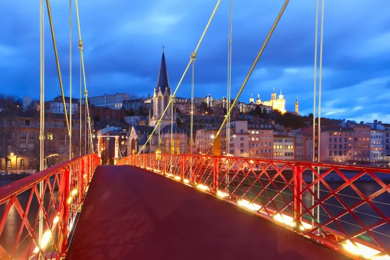 Panoramic view saint georges church footbridge across saone river old town with fourviere cathedral during evening blue hour lyon france